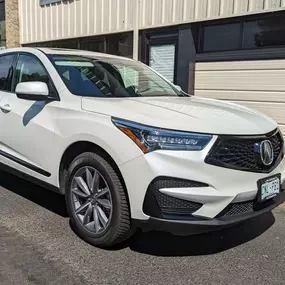 We did a Chrome Delete Vinyl Wrap on this white 2023 Acura RDX in our shop in Wheat Ridge!