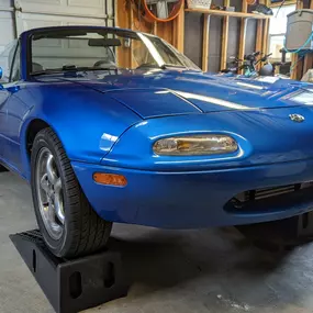 Partial front end clear bra wrap on this beautiful blue 1995 Mazda Miata MX 5 at the customer's home.