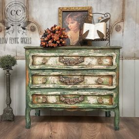 A dresser that was painted with Terra Clay paint by Dixie Belle in Greens and Cream colors, distressed