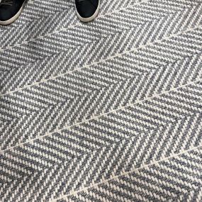 Grey and white chevron striped carpet.