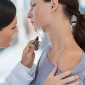 Advanced Dermatology & Skin Cancer Specialists - doc examining mole on woman neck