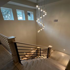 Remodeled staircase with pendant lighting and illuminated stairs