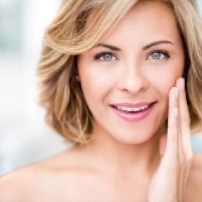 Advanced Dermatology & Skin Cancer Specialists - woman smiling with hand on face