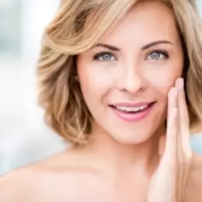 Advanced Dermatology & Skin Cancer Specialists - woman smiling with hand on face