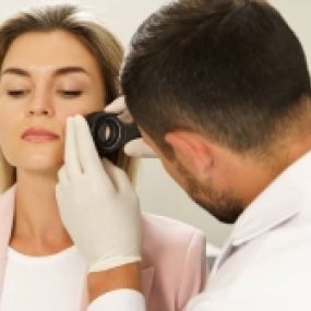 Desert Dermatology & Skin Cancer Specialists - doc examining womans face