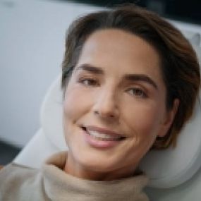 Desert Dermatology & Skin Cancer Specialists - woman smiling on derm chair