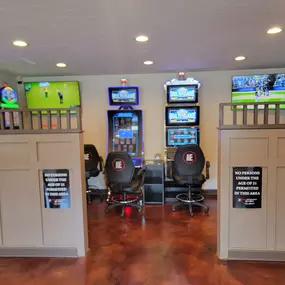 This image highlights the lively ambiance of Lucky 7's Lounge. It showcases a row of captivating slot machines, contributing to the exciting and energetic atmosphere of the venue