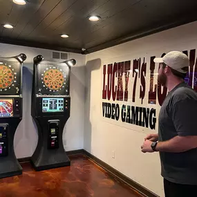 In this image, Lucky 7's Lounge reveals its dartboard area, where players can be seen engaging in friendly and competitive games. The lounge offers an enjoyable space for dart enthusiasts to showcase their skills.