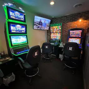 Brightly lit slot machines casting colorful reflections, adding to the lively ambiance of Lucky 7's Lounge