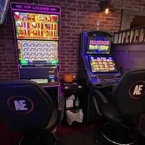 Close-up of a player's hand pressing the spin button on a slot machine, hoping for a lucky outcome at Lucky 7's Lounge.