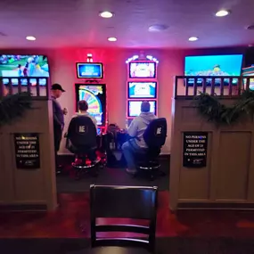 Row of slot machines at Lucky 7's Lounge, beckoning with their bright lights and thrilling gameplay.