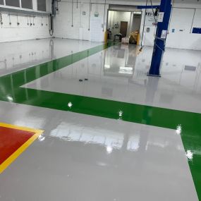 Grey resin flooring with green gangway