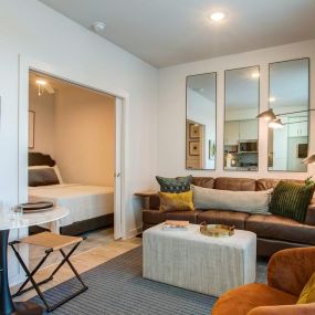 Open concept living room with home office nooks and covered balconies.