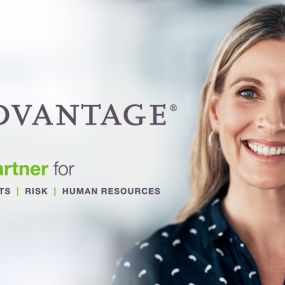 Business owner smiling next to CoAdvantage