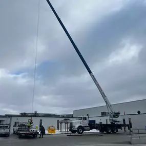 Loading roofing material onto roof