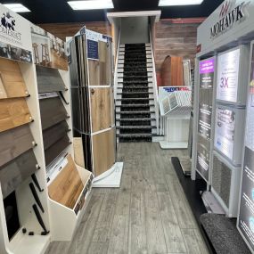 Visit our Durham store and explore the captivating hallway with a wide array of flooring samples. Ascend the stairs as you discover the perfect flooring options for your space. Our knowledgeable team is here to guide you along the way.