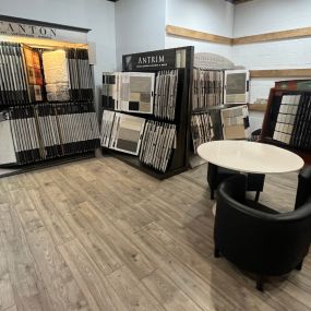 Step into a stylish room at USA Flooring Durham, where a table and chairs set the stage for memorable gatherings. Experience the perfect blend of comfort and style as you envision transforming your own space with our exceptional flooring options.
