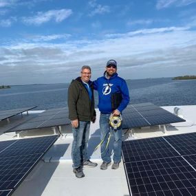 San and Ryder in Crystal Beach inspecting a TPO solar roof.