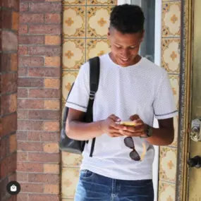 Sapien Designs' Multimedia Studios captured this image of a person in a white shirt and blue jeans, standing outside a building, emphasizing their SEO digital marketing capabilities.