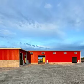 We're Building America recently completed a multi-use industrial steel frame building in collaboration with an industry partner in Thornton, ID. The building's bright red exterior and large doorways showcase our innovative and robust construction capabilities