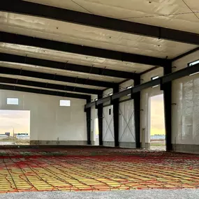 Interior construction phase of an 11,750 sq ft retail office building in Thornton, ID. Steel Concepts performing steel building erection, image features insulation and radiant floor heating setup prior to concrete pour.
