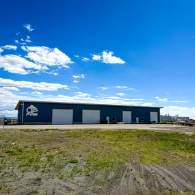 A newly completed 8,000 SQFT Steel Fabrication Machine Shop for UpFab LLC in St. Anthony, ID, constructed by Steel Concepts, Inc. This robust facility, featuring a prominent blue metal exterior and multiple large overhead access doors, was designed with efficiency, precision, and long-term growth in mind, supporting high-capacity operations and accommodating specialized machinery with advanced steel framing.