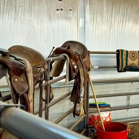 The interior of the newly completed 10,800 SQFT riding arena in Idaho Falls by Steel Concepts, Inc. Designed for durability, safety, and year-round use, this facility features a robust, open-span steel frame providing ample column-free space for equestrian activities. The image captures a detail of the functional interior, highlighting the practical aspects of the space built for riders and horses.