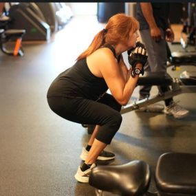 Elizabeth doing a squat during her personal training session.