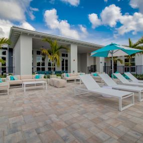 Sun loungers and covered veranda at Everly Luxury Apartments in Naples FL