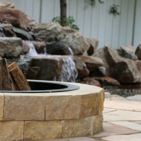a fire pit and water feature are the perfect combination for your outdoor space