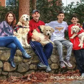 Beth and Steve Weiss with their family, including the golden retriever trainees.