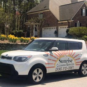 Sunrise Cleaning Services vehicle in front of client home
