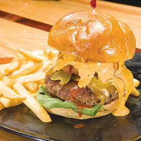 Looking for a place to enjoy pizza, chicken wings and a cold brew, while watching sports on TV? At Musketeers Bar & Grill, you'll find delicious food, over 100 beers, a full bar, and Ohio sports.
Known for our legendary pizza and jumbo wings, we take bar food to the next level! We make everything from scratch, including our savory pizza sauce and more than a dozen zesty chicken wing sauces. You won't find any bigger or tastier chicken wings in Northeast Ohio. We oven roast our wings then fry the