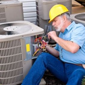 Technician working on AC repairs in Houston.