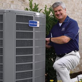 Technician working on AC repairs in Houston.