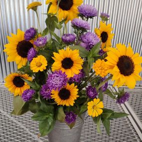 Fresh cut sunflowers, zinnias, and purple asters.