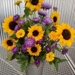 Fresh cut sunflowers, zinnias, and purple asters.