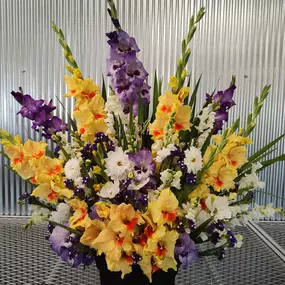 Funeral spray of flowers with gladiolus and cosmos.