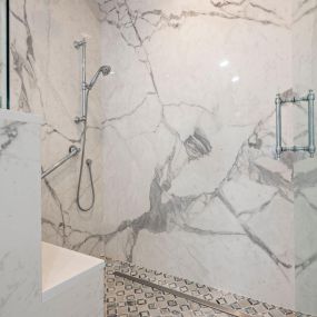 A gorgeous shower transformation in white & gray.