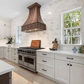 Kitchen remodel with white Showplace cabinetry and gorgeous hood