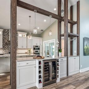 A kitchen renovation in Stuart, Florida where a wall was removed and replaced with a custom buffet & beams. Stunning craftsmanship!