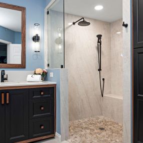 Shower remodel with frameless glass and quartz slab walls