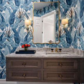 A fun Powder Bath refresh with a tropical vibe including Kohler plumbing fixtures, Pompeii Quartz countertop, and Showplace Cabinetry.