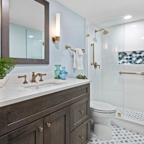 Gorgeous renovation with frameless glass, gold plumbing fixtures