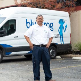 Service tech in front of a bluefrog Plumbing + Drain service van ready to install water filtration systems in New Orleans LA homes.