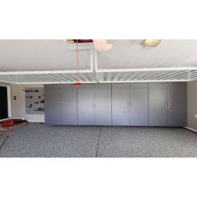Garage makeover  with custom cabinets, epoxy floor, overhead storage and slat wall.