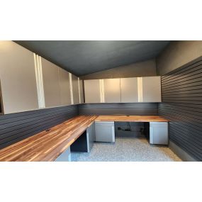 Sleek cabinets, slat wall and butcher block counter tops and epoxy decorative flake flooring.