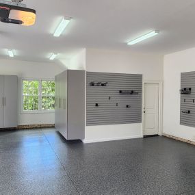 Slatwall, large cabinets and epoxy flooring.