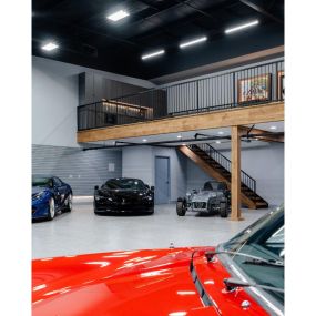 A garage fit for an F1 driver. This space exudes luxury and sophisticatgion while providing ample room to showcase your impressive car collection and achievements. With its sleek design and high-end finishes, this space is perfect for hosting events or simply enjoying your passions in style.