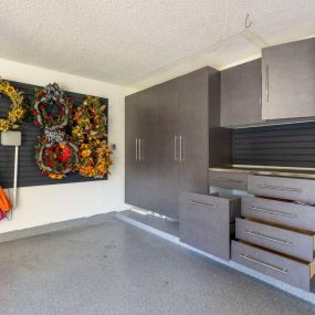 Discover the joy of clutter-free with custom cabinets and slatwall for all your storage needs!